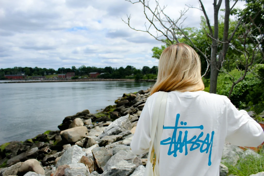The Significance of Counter Culture in Streetwear - Image of a female wearing a Stussy brand T-Shirt