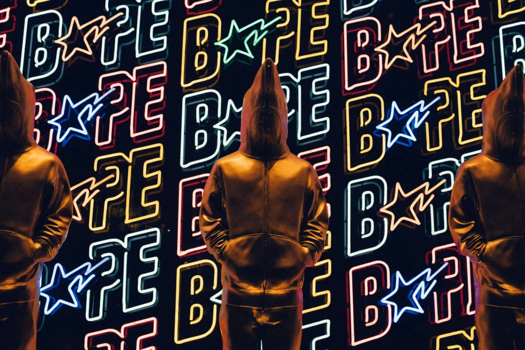 The Significance of Counter Culture in Streetwear - Graphic of a hooded figure with BAPE logo background