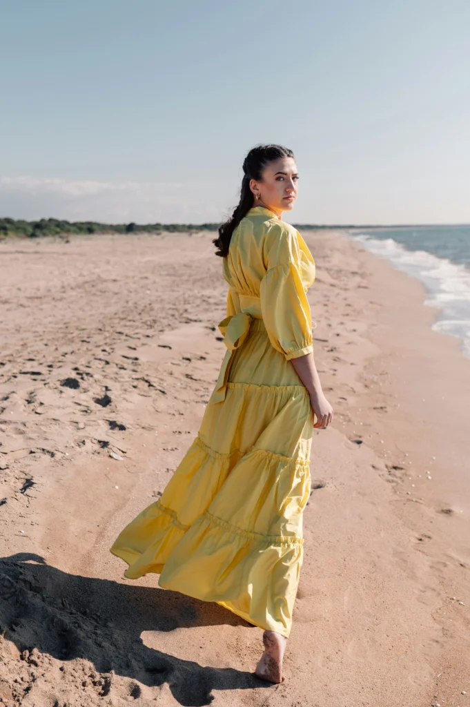 Elevate your summer style - Oddfunk. Girl in a summer dress walking on a beach